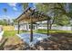 Modern pergola surrounded by lush green grass in a well-maintained backyard at 4461 Shore Acres Ne Blvd, St Petersburg, FL 33703