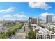 Scenic city view featuring a wide road framed by modern buildings and lush greenery under a blue sky at 449 S 12Th St # 1201, Tampa, FL 33602