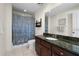 Well-lit bathroom featuring a decorative shower curtain and a dark wood vanity with a granite countertop at 449 S 12Th St # 1201, Tampa, FL 33602