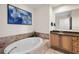 Bathroom showcasing a soaking tub, tiled surround, and a vanity with ample storage at 449 S 12Th St # 1201, Tampa, FL 33602