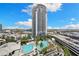 Aerial view of a modern high-rise building with luxurious pools and city skyline at 449 S 12Th St # 1201, Tampa, FL 33602
