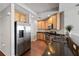 Kitchen featuring stainless steel appliances, dark countertops and wood cabinets at 449 S 12Th St # 1201, Tampa, FL 33602