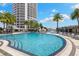 Expansive pool area with lounge chairs and waterfall feature set against a backdrop of high-rise buildings at 449 S 12Th St # 1201, Tampa, FL 33602