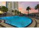 Luxurious community pool with waterfall feature, surrounded by palm trees and lounge chairs, offering a resort-style experience at 449 S 12Th St # 1201, Tampa, FL 33602