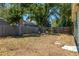 Leafy backyard with a rustic firepit area framed by mature trees and a privacy fence for secluded enjoyment at 4531 7Th N Ave, St Petersburg, FL 33713