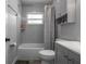 Modern bathroom featuring a shower-tub combo, grey tile, and vanity storage space at 4531 7Th N Ave, St Petersburg, FL 33713