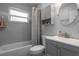 Modern bathroom featuring a shower-tub combo, grey tile, and vanity storage space at 4531 7Th N Ave, St Petersburg, FL 33713