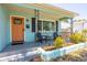 Charming front porch featuring a cozy seating area and colorful curb appeal at 4531 7Th N Ave, St Petersburg, FL 33713