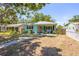 Exterior view of a well-maintained single-story home with a manicured lawn, and a charming fence at 4531 7Th N Ave, St Petersburg, FL 33713
