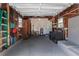 Spacious garage interior featuring laundry area, utility sink, water heater, and ample storage space with rustic wood paneling at 4531 7Th N Ave, St Petersburg, FL 33713