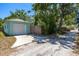 View of the detached garage featuring a light blue exterior, white garage door, and a convenient driveway at 4531 7Th N Ave, St Petersburg, FL 33713