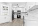 Well-lit kitchen with white cabinets, stainless steel appliances, and a decorative shelf with a 'Let's Eat' sign at 4531 7Th N Ave, St Petersburg, FL 33713