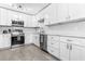 Bright kitchen with white cabinets, stainless steel appliances, granite countertops, and tile flooring at 4531 7Th N Ave, St Petersburg, FL 33713