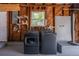 Laundry machines in the garage featuring modern appliances against a rustic wood paneled wall with a window and wire shelves at 4531 7Th N Ave, St Petersburg, FL 33713