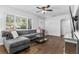 Inviting living room with hardwood floors, a stylish gray sectional, and ample natural light from a large window at 4531 7Th N Ave, St Petersburg, FL 33713