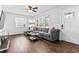 Bright living room featuring hardwood floors, a comfortable gray sectional sofa, and natural light from a large window at 4531 7Th N Ave, St Petersburg, FL 33713