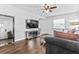 Cozy living room with hardwood floors, a comfortable sofa, and a modern entertainment center with a mirrored accent at 4531 7Th N Ave, St Petersburg, FL 33713