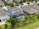 Aerial view of a home with a screened pool, and lush landscaping in a residential neighborhood at 4770 Ballantrae Blvd, Land O Lakes, FL 34638