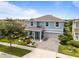 Beautiful aerial view of a blue two-story home with lush landscaping and a paved driveway at 4770 Ballantrae Blvd, Land O Lakes, FL 34638