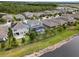 Serene aerial of a neighborhood featuring a fenced backyard, lush grass, and a relaxing lake view at 4770 Ballantrae Blvd, Land O Lakes, FL 34638