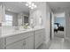 Bathroom with a double vanity sink, tile floors, and a view of the Primary bedroom at 4770 Ballantrae Blvd, Land O Lakes, FL 34638