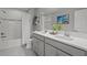 Bright bathroom featuring double vanity, tiled floors, and shower over tub at 4770 Ballantrae Blvd, Land O Lakes, FL 34638
