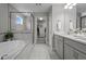 Luxurious bathroom featuring a soaking tub, glass shower, and double vanity at 4770 Ballantrae Blvd, Land O Lakes, FL 34638