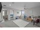 Spacious carpeted room with multiple seating areas, desks, and large windows at 4770 Ballantrae Blvd, Land O Lakes, FL 34638