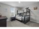 Bedroom with a bunk bed set, dark wood dresser, and window with blinds at 4770 Ballantrae Blvd, Land O Lakes, FL 34638