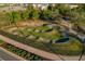 Aerial view of a bike park with rolling hills and winding tracks, perfect for outdoor recreation and fitness at 4770 Ballantrae Blvd, Land O Lakes, FL 34638