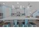 Bright kitchen featuring a large island, modern lighting, and stainless steel appliances at 4770 Ballantrae Blvd, Land O Lakes, FL 34638