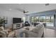 Comfortable living room featuring a large sliding glass door with views of the pool and modern decor at 4770 Ballantrae Blvd, Land O Lakes, FL 34638