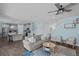Open-concept living space that flows to the kitchen with a large gray couch at 4770 Ballantrae Blvd, Land O Lakes, FL 34638