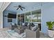 Covered patio with comfortable seating area and a view of the pool and backyard at 4770 Ballantrae Blvd, Land O Lakes, FL 34638