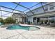 Inviting screened-in pool and spa with spacious brick paver patio and outdoor seating at 4770 Ballantrae Blvd, Land O Lakes, FL 34638