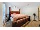 Spacious bedroom featuring a striking four-poster bed and neutral wall decor at 4916 Rolling Green Dr, Wesley Chapel, FL 33543