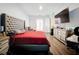 Spacious bedroom featuring hardwood floors, and an entertainment center with a TV at 4916 Rolling Green Dr, Wesley Chapel, FL 33543