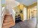 Entryway features stairs, tiled floors, a beverage area and decorative wall art and clock at 4916 Rolling Green Dr, Wesley Chapel, FL 33543