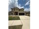Charming two-story home with a well-maintained lawn and attached two-car garage at 4916 Rolling Green Dr, Wesley Chapel, FL 33543
