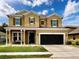 Charming two-story home featuring a covered entryway, two-car garage, and well-maintained lawn at 4916 Rolling Green Dr, Wesley Chapel, FL 33543