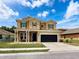 Charming two-story home featuring a covered entryway, two-car garage, and well-maintained lawn at 4916 Rolling Green Dr, Wesley Chapel, FL 33543