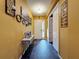 Inviting hallway with stylish decor, leading to the front door with tile flooring throughout at 4916 Rolling Green Dr, Wesley Chapel, FL 33543