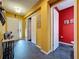 Bright hallway leading to a half bath and the front door with unique decorative elements at 4916 Rolling Green Dr, Wesley Chapel, FL 33543