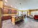 Open concept kitchen with island seating and a view to the dining room and living area at 4916 Rolling Green Dr, Wesley Chapel, FL 33543