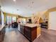 Spacious kitchen with granite countertops, a kitchen island, stainless steel appliances, and an open floor plan at 4916 Rolling Green Dr, Wesley Chapel, FL 33543