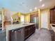 Spacious kitchen with granite countertops, a kitchen island, stainless steel appliances, and an open floor plan at 4916 Rolling Green Dr, Wesley Chapel, FL 33543