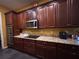 Spacious kitchen features granite countertops, stainless steel appliances and dark wood cabinets at 4916 Rolling Green Dr, Wesley Chapel, FL 33543