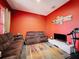 Cozy living room features comfortable seating, bright accent wall and ample space for relaxation or entertaining at 4916 Rolling Green Dr, Wesley Chapel, FL 33543