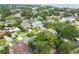 Scenic aerial view of a neighborhood with lush landscaping and diverse architectural styles near the water at 5005 W Evelyn Dr, Tampa, FL 33609