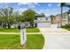 Shot of the two-story home featuring an attached two-car garage, mailbox, and well-manicured lawn at 5005 W Evelyn Dr, Tampa, FL 33609